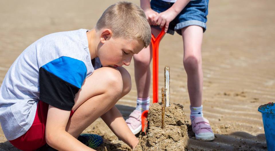 Boy building sandcastle